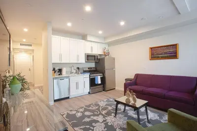a living room with a purple couch and a kitchen at 1-Bedroom with Cali King Size Bed in San Diego in San Diego