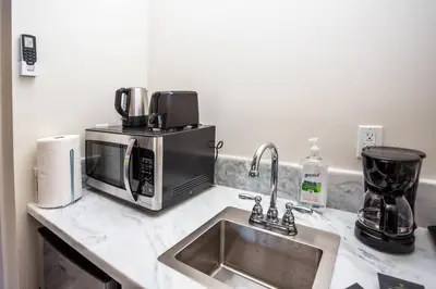 a kitchen counter with a sink and a microwave at Awesome Balboa Park View with Huge Balcony in SD in San Diego