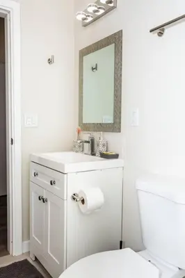 a white bathroom with a toilet and a mirror at Awesome Balboa Park View with Huge Balcony in SD in San Diego