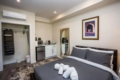 a bedroom with a large bed with towels on it at Awesome Balboa Park View with Huge Balcony in SD in San Diego