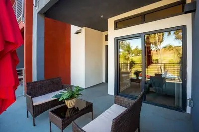 a balcony with two chairs and a table on a patio at Awesome Balboa Park View with Huge Balcony in SD in San Diego