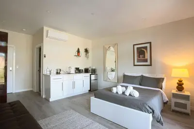a bedroom with a bed and a sink in it at Awesome Balboa and Downtown View with Cozy Patio in San Diego