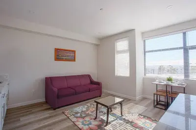 a living room with a red couch and a table at Luxurious Design One Bedroom Apt near Balboa Park in San Diego