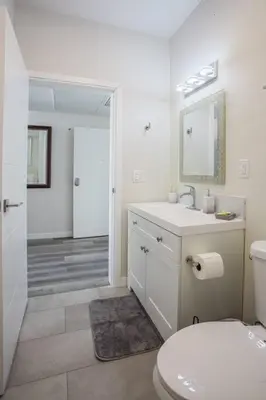 a white bathroom with a toilet and a sink at Luxurious Design One Bedroom Apt near Balboa Park in San Diego