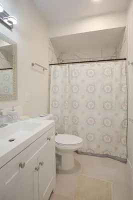 a bathroom with a toilet and a shower curtain at Cute Studio With Large Balcony and Great Park View in San Diego