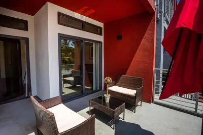 a patio with chairs and a table on a balcony at Cute Studio With Large Balcony and Great Park View in San Diego