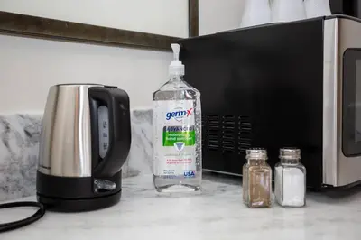 a bottle of water sitting next to a microwave at Cute Studio With Large Balcony and Great Park View in San Diego