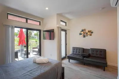 a bedroom with a bed and a couch in it at Cute Studio With Large Balcony and Great Park View in San Diego