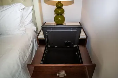 a nightstand with a lamp on it next to a bed at Luxurious Studio in Heart of San Diego w Cali King in San Diego