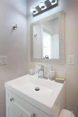 a white bathroom with a sink and a mirror at Luxurious Studio in Heart of San Diego w Cali King in San Diego