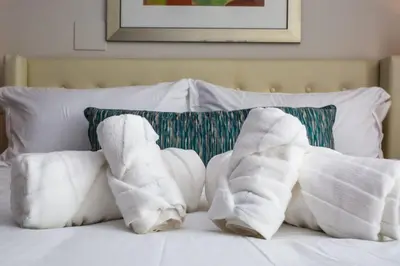 two pairs of white socks on a bed with pillows at Luxurious Studio in Heart of San Diego w Cali King in San Diego