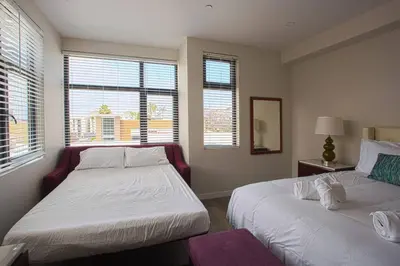 two beds in a room with two windows at Downtown View 4 Sleepers Studio- Great for Getaway in San Diego