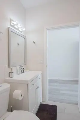 a bathroom with a toilet and a sink and a mirror at Downtown View 4 Sleepers Studio- Great for Getaway in San Diego