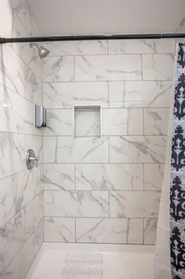 a bathroom with a shower with white marble tiles at Downtown View 4 Sleepers Studio- Great for Getaway in San Diego