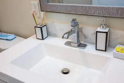 a white bathroom sink with toothbrushes and a mirror at Downtown View 4 Sleepers Studio- Great for Getaway in San Diego
