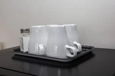 a tray of white mugs sitting on a table at Downtown View 4 Sleepers Studio- Great for Getaway in San Diego