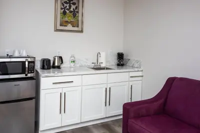 a kitchen with a sink and a microwave and a couch at One Bedroom Apartment with Luxurious Furnitures in San Diego