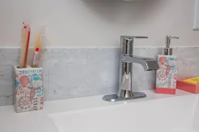 a bathroom counter with a sink and a foss at One Bedroom Apartment with Luxurious Furnitures in San Diego