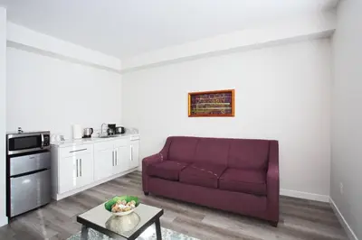 a living room with a purple couch and a kitchen at One Bedroom Apartment with SD Downtown View in San Diego