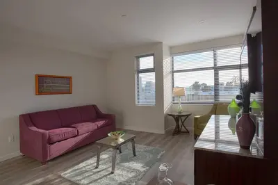 a living room with a purple couch and a table at One Bedroom Apartment with SD Downtown View in San Diego
