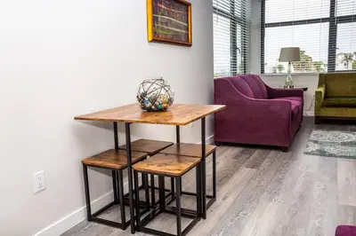 a living room with a table and a purple couch at One Bedroom Apartment with San Diego Downtown View in San Diego
