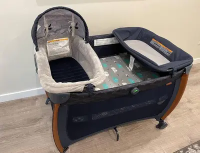 a baby car seat in a suitcase on the floor at Cali King Size One Bedroom Luxurious Suite in DTSD in San Diego