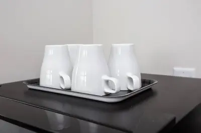 a tray with four white cups on a table at Prime Location - Awesome View -1 bedroom Apartment in San Diego