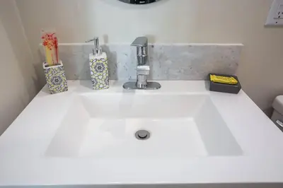 a kitchen sink with a faucet and two vases on it at Prime Location - Awesome View -1 bedroom Apartment in San Diego