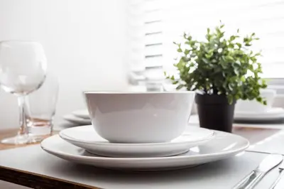 a white cup and saucers on a table at Spacious 1 Bedroom Apartment in Balboa Park in San Diego