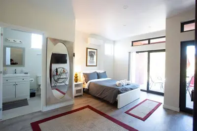 a bedroom with a bed and a large mirror at Spacious Studio with Incredible Balboa Park View in San Diego