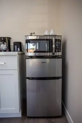 a microwave on top of a refrigerator in a kitchen at Spacious Studio with Incredible Balboa Park View in San Diego