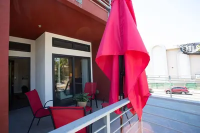 a pink umbrella on a balcony of a building at Spacious Studio with Incredible Balboa Park View in San Diego