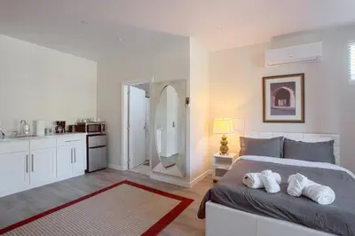 a bedroom with a large bed and a bathroom at Spacious Studio with Incredible Balboa Park View in San Diego