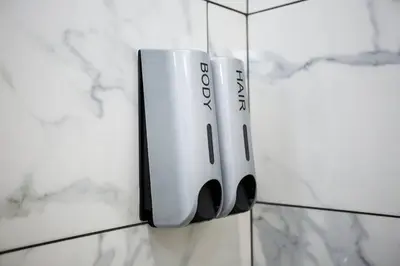 a soap dispenser hanging on a wall at Steps to Balboa Park- Brand New Apt - Cozy Studio in San Diego