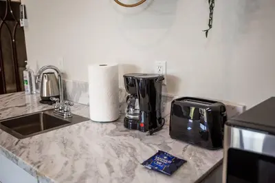 a kitchen counter with a coffee maker and a toaster at Steps to Balboa Park- Brand New Apt - Cozy Studio in San Diego
