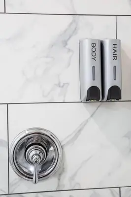 a sink with a faucet on a white counter at 1 Bedroom Apartment with Luxurious Design in SD in San Diego