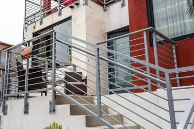 a metal stair railing on the side of a building at 1 Bedroom Apartment with Luxurious Design in SD in San Diego