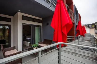 a balcony with two red umbrellas on a building at Studio with Large Balcony- San Diego Gateway in San Diego