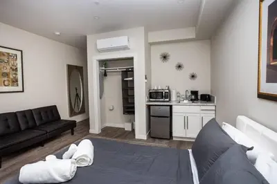 a living room with a couch and a kitchen at Studio with Large Balcony- San Diego Gateway in San Diego