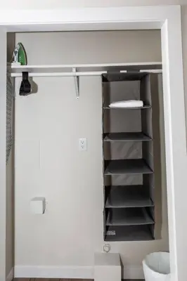 a bathroom with a toilet and a closet with shelves at Studio with Large Balcony- San Diego Gateway in San Diego