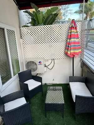 a patio with chairs and a table and an umbrella at Studio with Private Entrance next to Balboa Park in San Diego