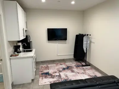 a living room with a couch and a tv on the wall at Studio with Private Entrance next to Balboa Park in San Diego