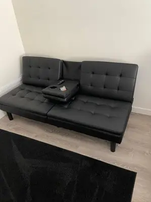 a black couch with a suitcase on top of it at Studio with Private Entrance next to Balboa Park in San Diego