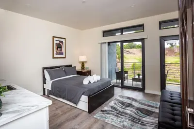 a bedroom with a bed and a balcony at Explore San Diego-Balboa Park-Little Italy-Gaslamp in San Diego