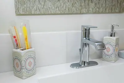 a bathroom sink with a toothbrush holder and a faucet at Explore San Diego-Balboa Park-Little Italy-Gaslamp in San Diego