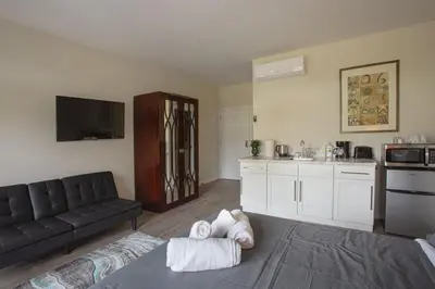 a living room with a couch and a kitchen at Explore San Diego-Balboa Park-Little Italy-Gaslamp in San Diego