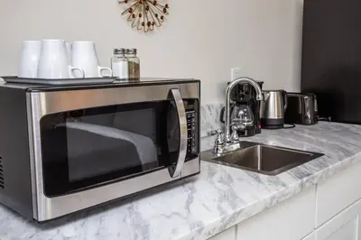a microwave sitting on a counter next to a sink at Studio with Beautiful View next to Downtown in San Diego