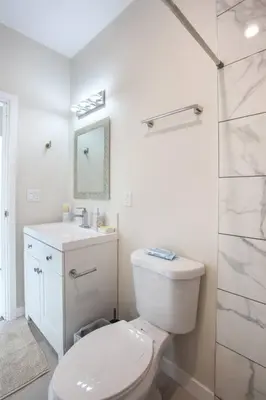 a white bathroom with a toilet and a shower at Studio with Beautiful View next to Downtown in San Diego