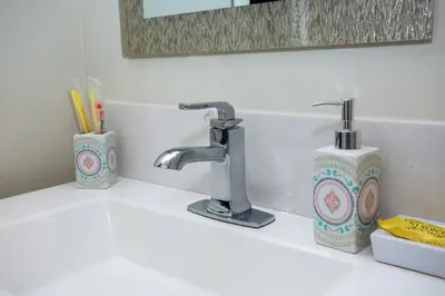 a bathroom sink with two faucets on a counter at Studio with Beautiful View next to Downtown in San Diego