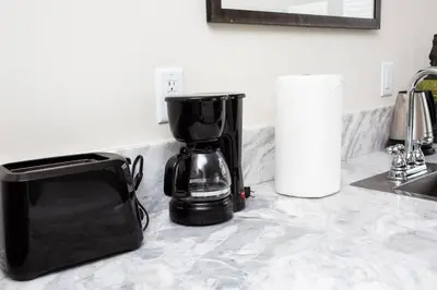 a black coffee maker sitting on a kitchen counter at Premier Location with Great Scenic Downtown View in San Diego